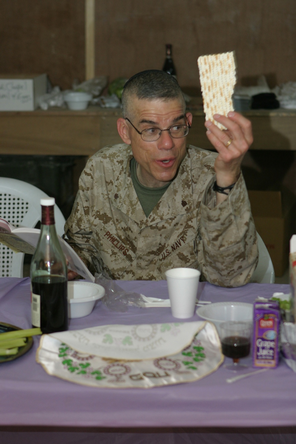 Lt Commander Seth D. Phillips reads from the Haggadah