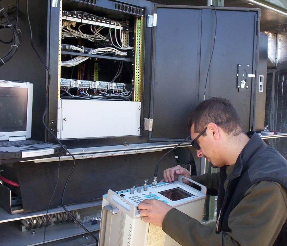 Gus Carvajal runs tests on the radio equipment