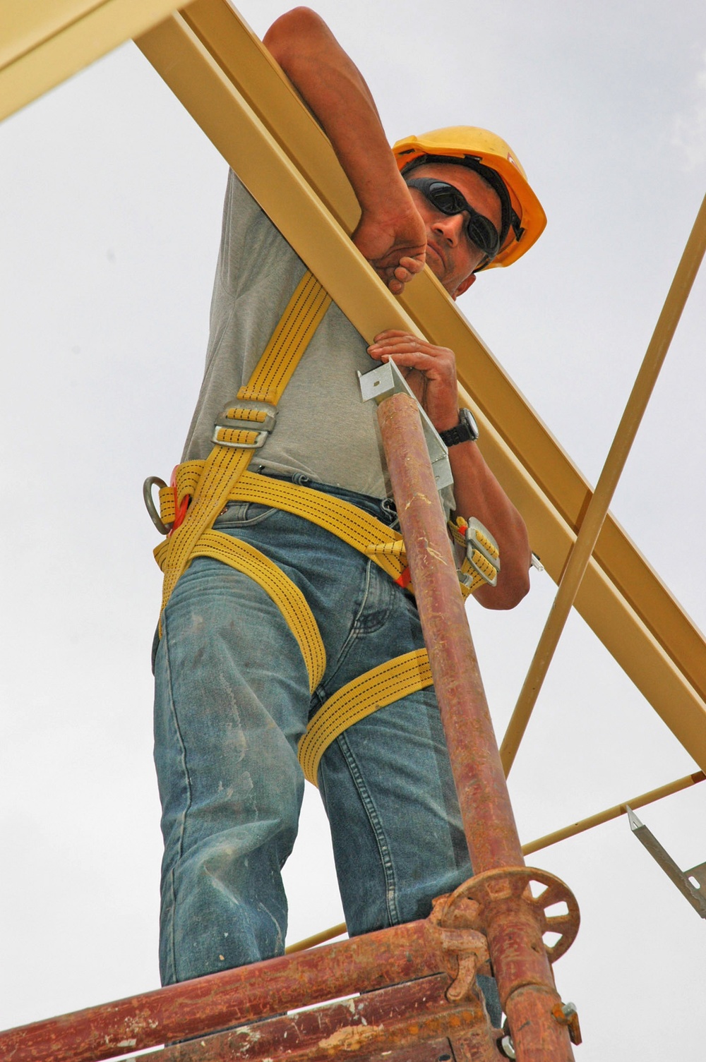 Construction employees work on the structure