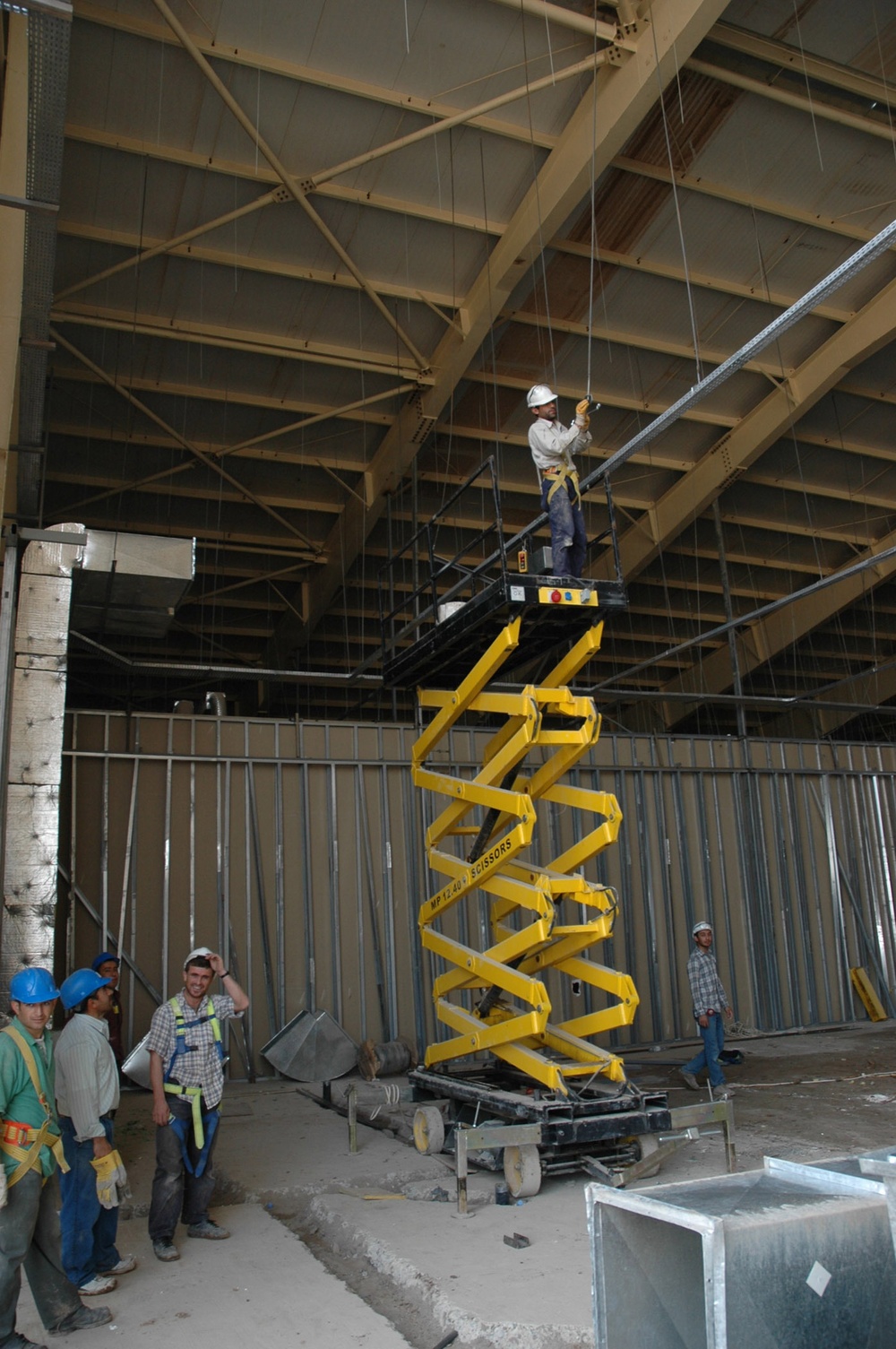 Construction employees work on the structure