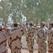 Soldiers salute the Iraqi flag