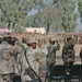 Soldiers of the Iraqi Army salute the Iraqi flag