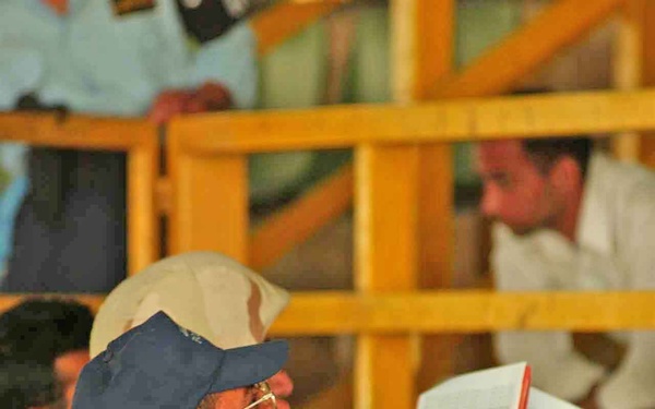 An Iraqi Policeman calls the names of the Iraqi men