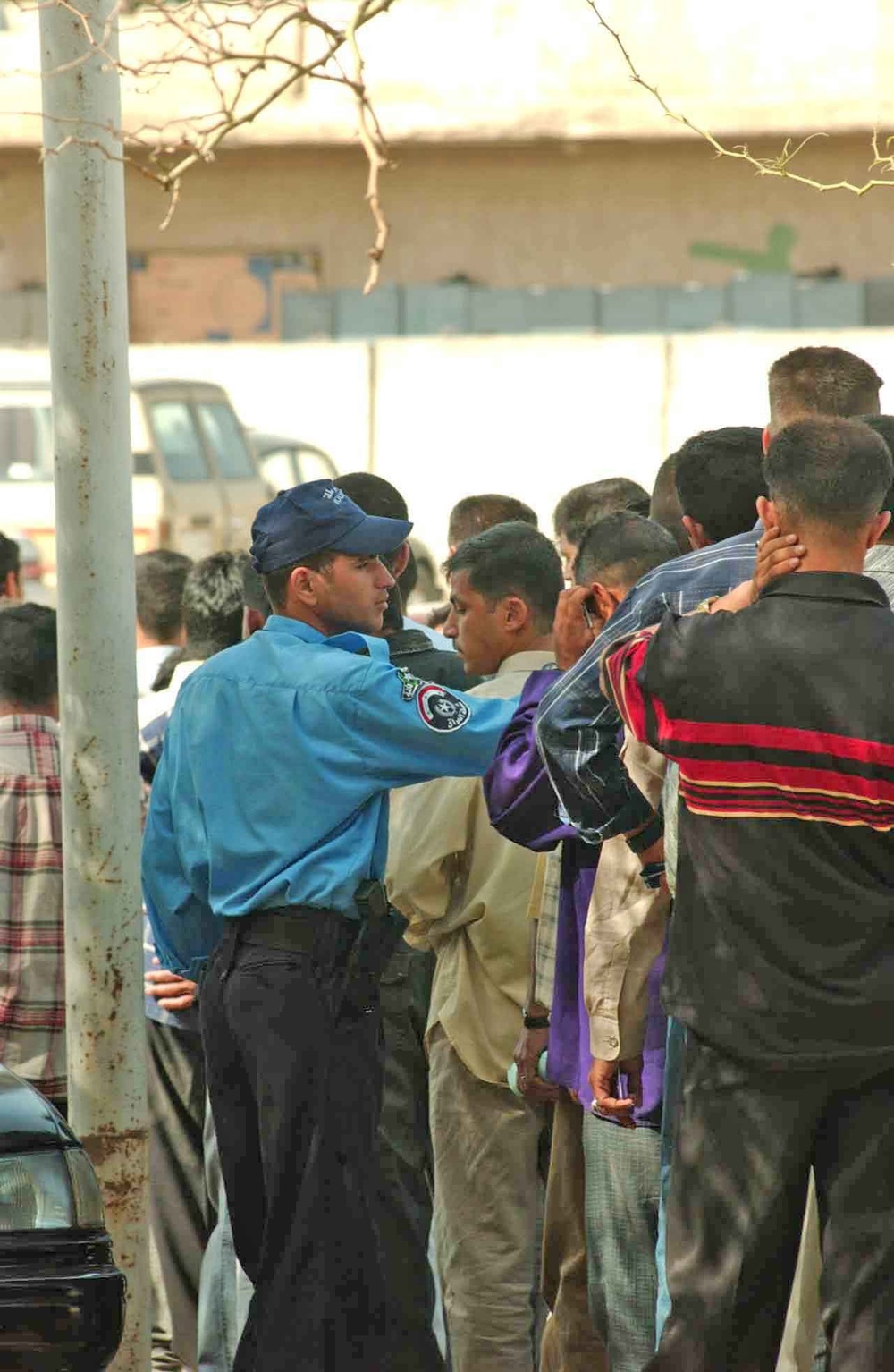 Recruits are lined up by the Iraqi Police Academy instructors