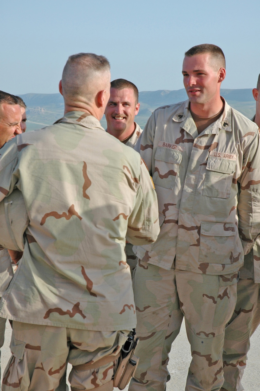 Sgt. Barker shakes the hand of Sgt. Maj. Jeffrey J. Mellinger