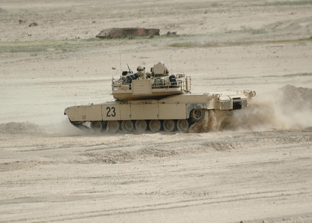 A tank crew quickly maneuvers their M1 Abrams Tank