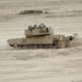 A tank crew quickly maneuvers their M1 Abrams Tank