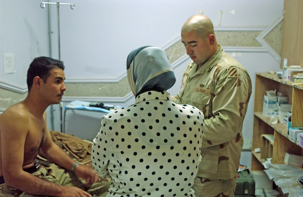 Spc. Eric Ingram checks an Iraqi Army Soldiers progress