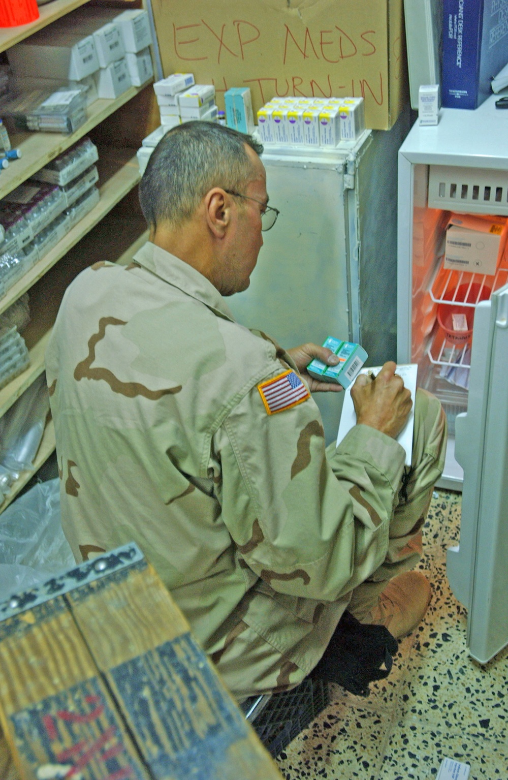Spc. Turner inventories medicene at the troop medical clinic