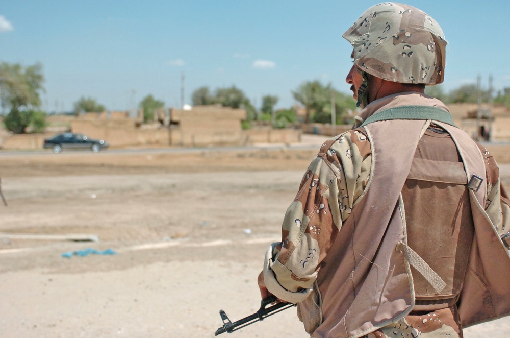A Soldier stands vigilantly at his post near the Western Baghdad