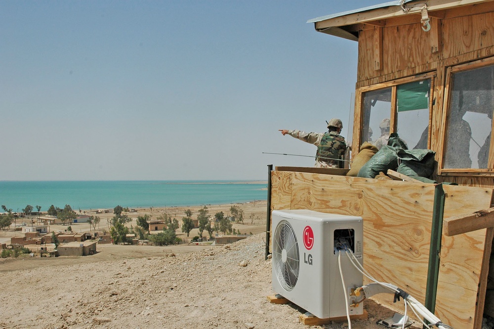 Soldiers look out from an observation post