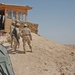 Soldiers survey the desert from their observation post