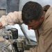 Lcpl. Figueroa changes the oil in one of the many generators