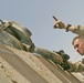 Lcpl. Bailey signals for the Marine operating an M88 tank