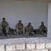 Truck drivers take a break from the heat inside a house