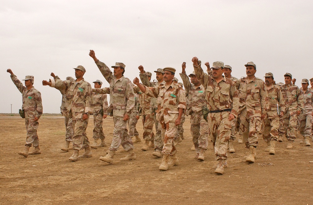 Iraqi Soldiers march in formation while practicing drill