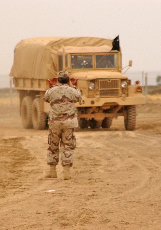 An Iraqi National Guard driving instructor ground guides