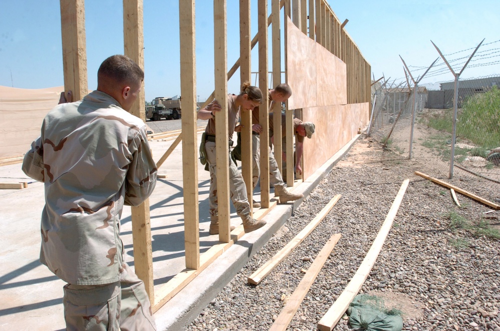 A team of carpenters set the frame of a maintenance bay