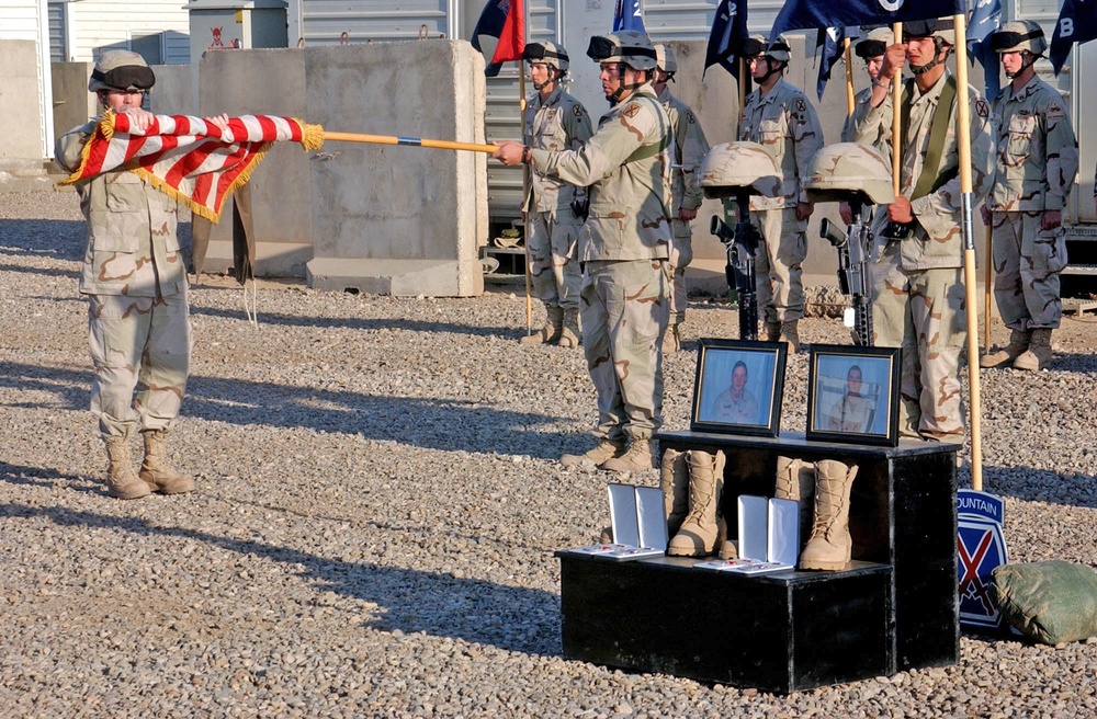 Spc. McLaughlin unveils the American Flag during a memorial cere