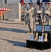 Spc. McLaughlin unveils the American Flag during a memorial cere