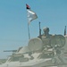 An Iraqi Soldier stands ready in the turret of his MTLB