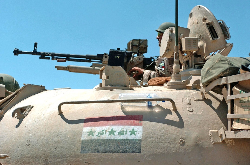 An Iraqi tank commander scans his sector