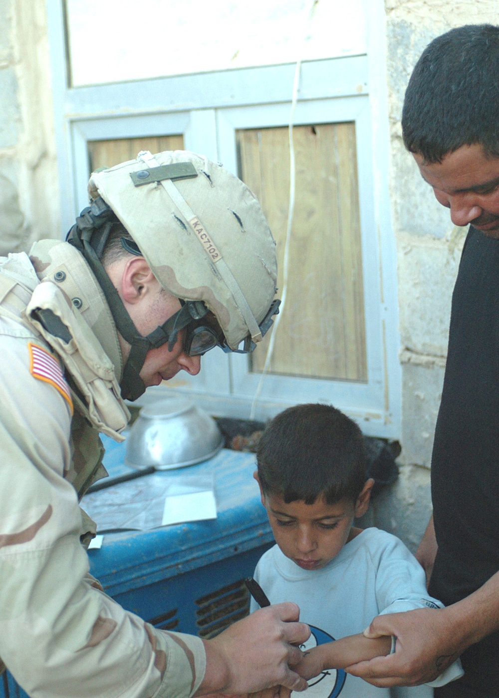 1st Lt. Colomb draws a heart on the hand of an child