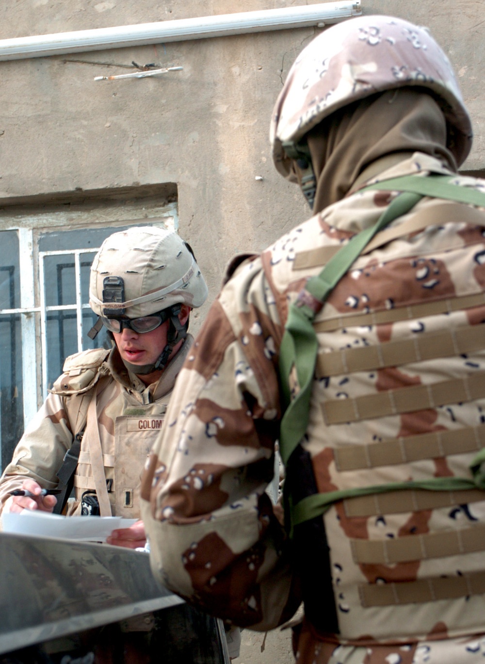 Colomb checking map during a cordon and search operation