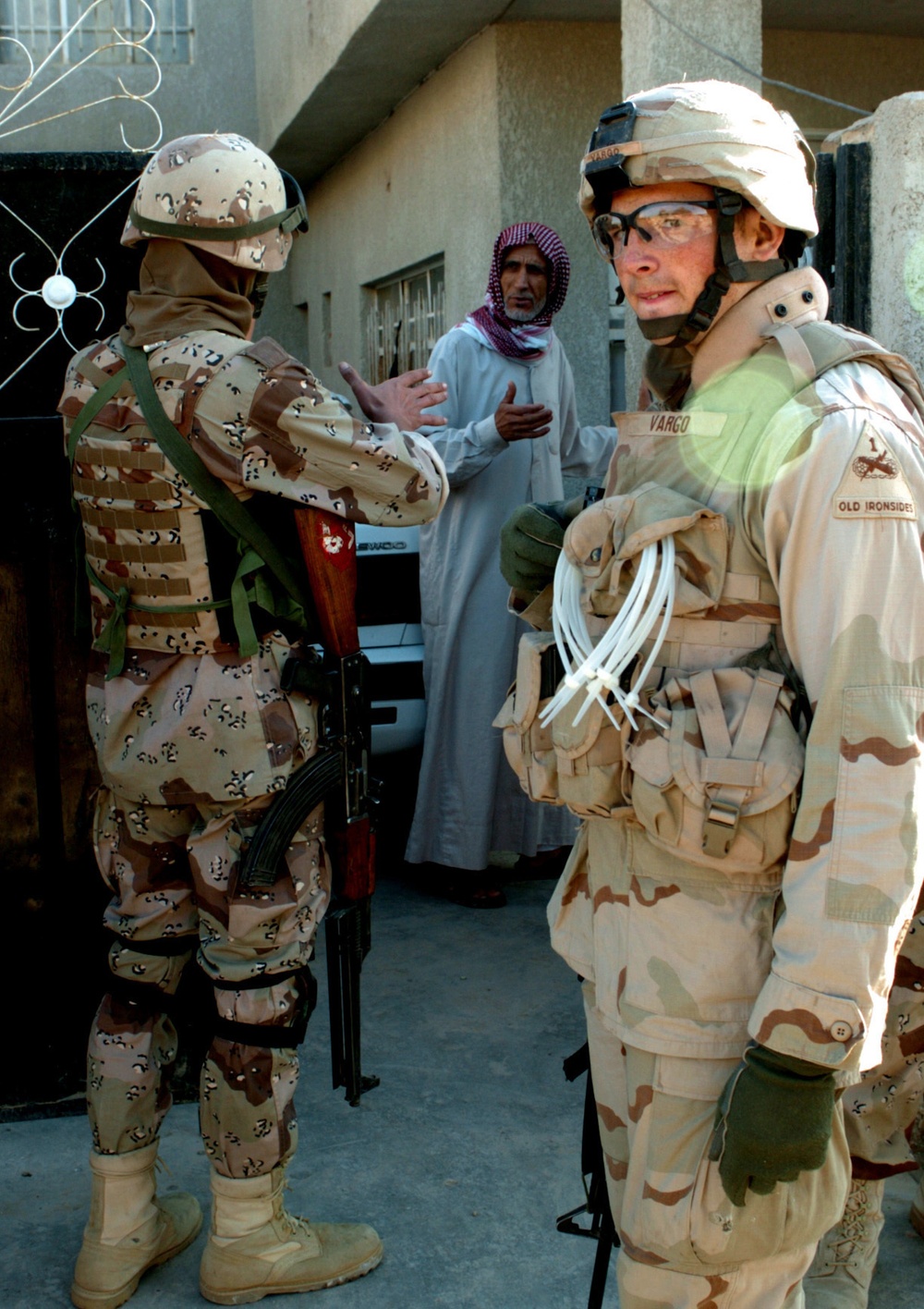 Vargo and iraqi soldier prepare to search a house