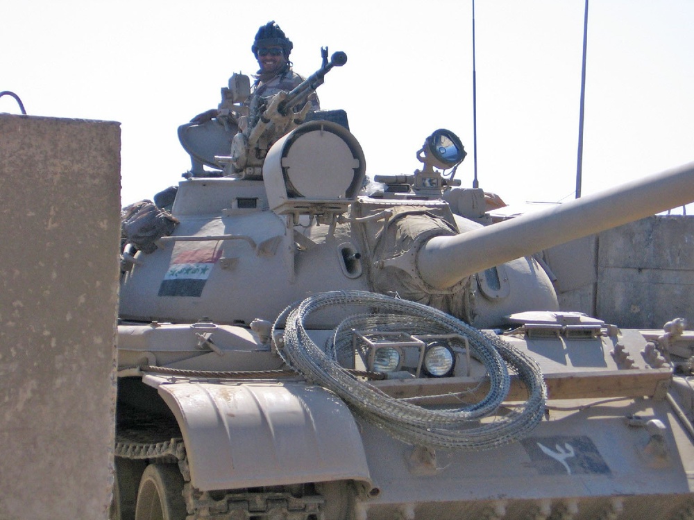 A Tank co. smiles as his T-55 Main Battle Tank blocks insurgents