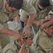 Iraqi police place bandages around each others heads