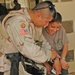 Lt. Col Garcia compares watches with an Iraqi child