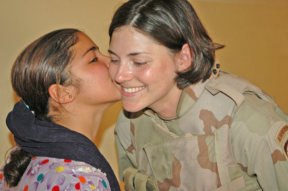 1st Lt. Taylor receives a gift of thanks from an Iraqi girl