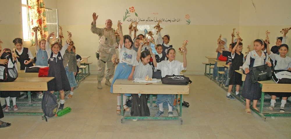 Staff Sgt. Butch A. Drake hands out Beanie Babies