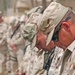 Soldiers bow their heads during the memorial service