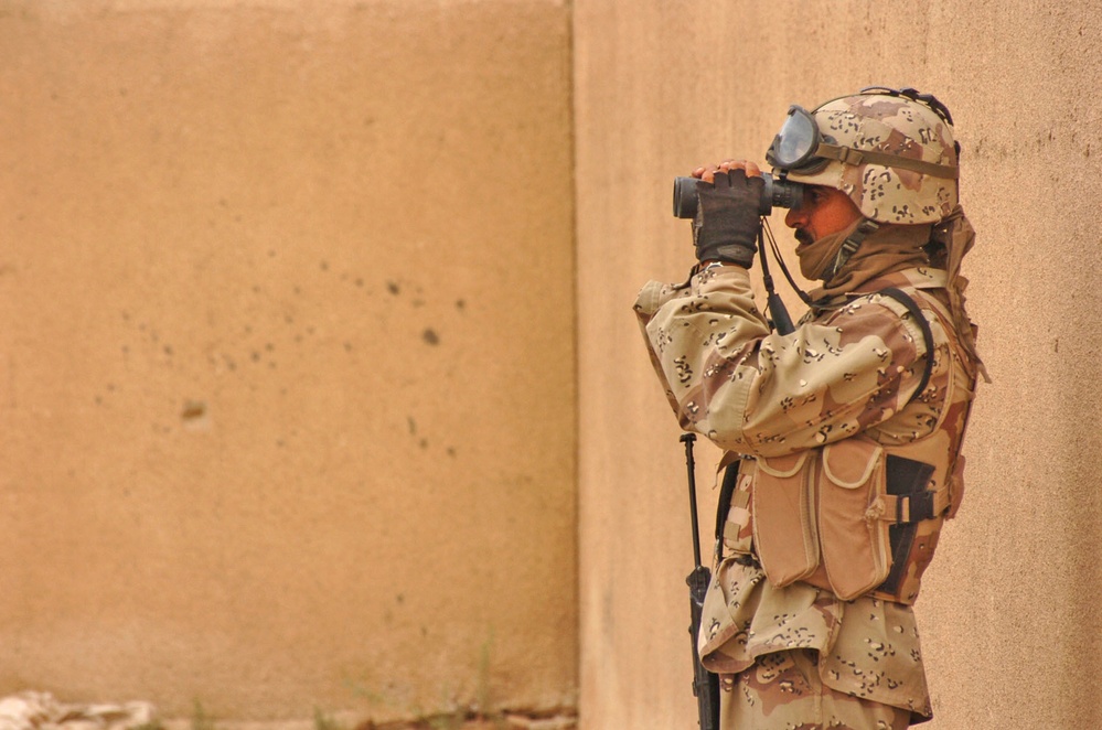 An Iraqi Army Soldier observes potential enemy action