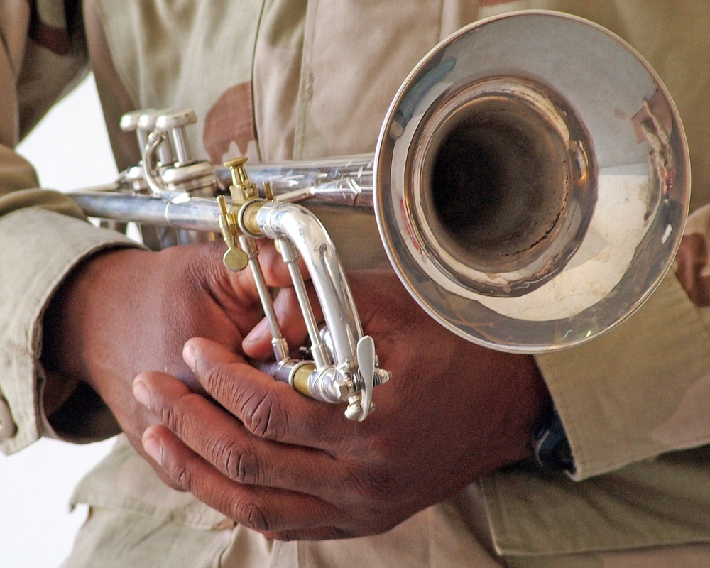 A bugler waits to play Taps during a memorial ceremony