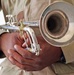 A bugler waits to play Taps during a memorial ceremony