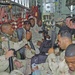 More than 60 Soldiers are packed into a C-130 aircraft