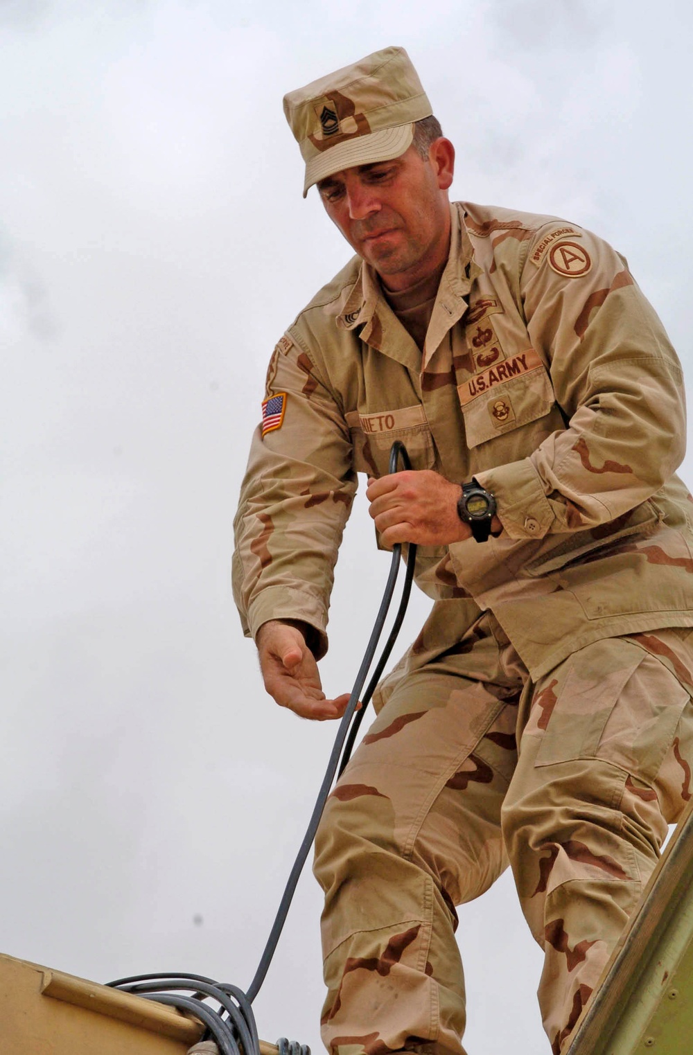 Master Sgt. James Nieto pulls communications cables