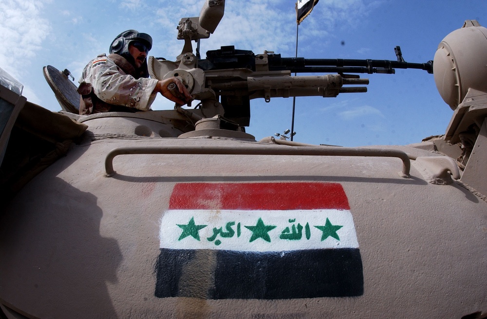 A Soldier pulls security from a tank in Abu Ghraib