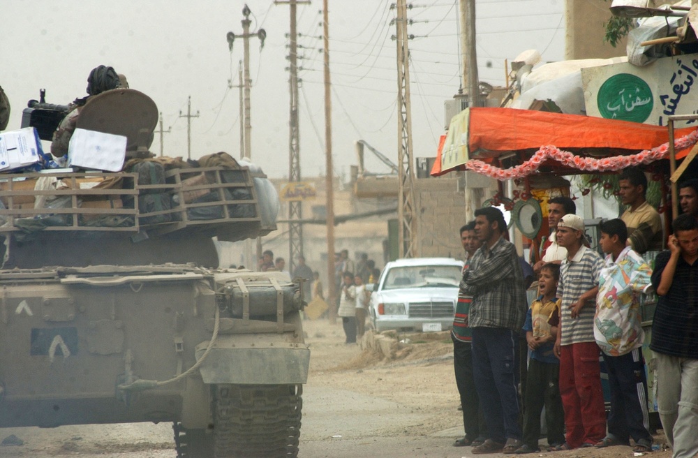 Soldiers patrol the streets of Abu Ghraib