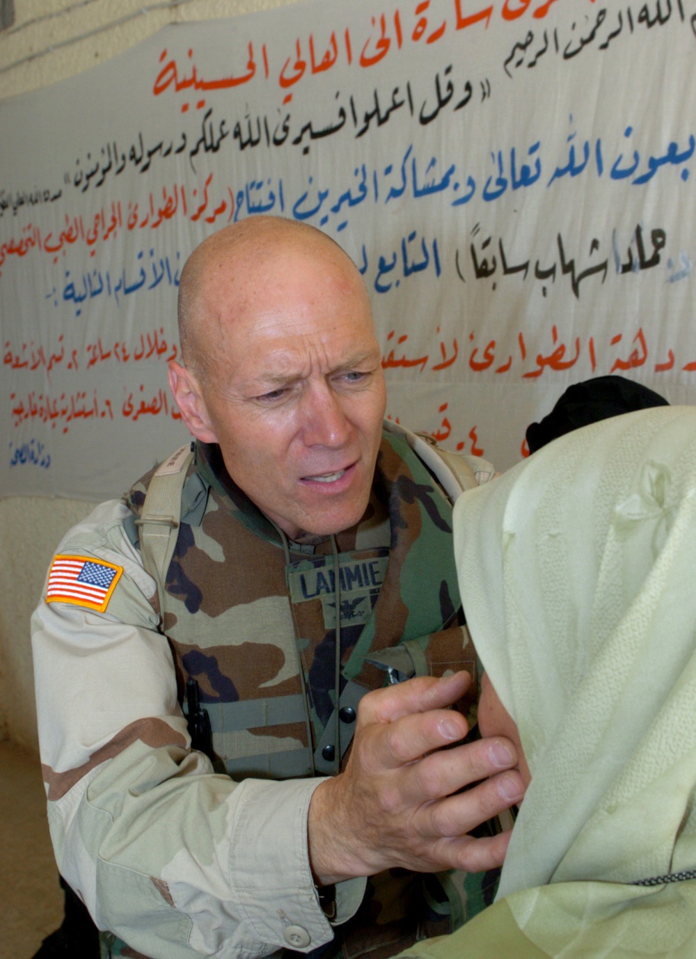 Dr. (Col.) John Lammie examines an Iraqi woman eyes