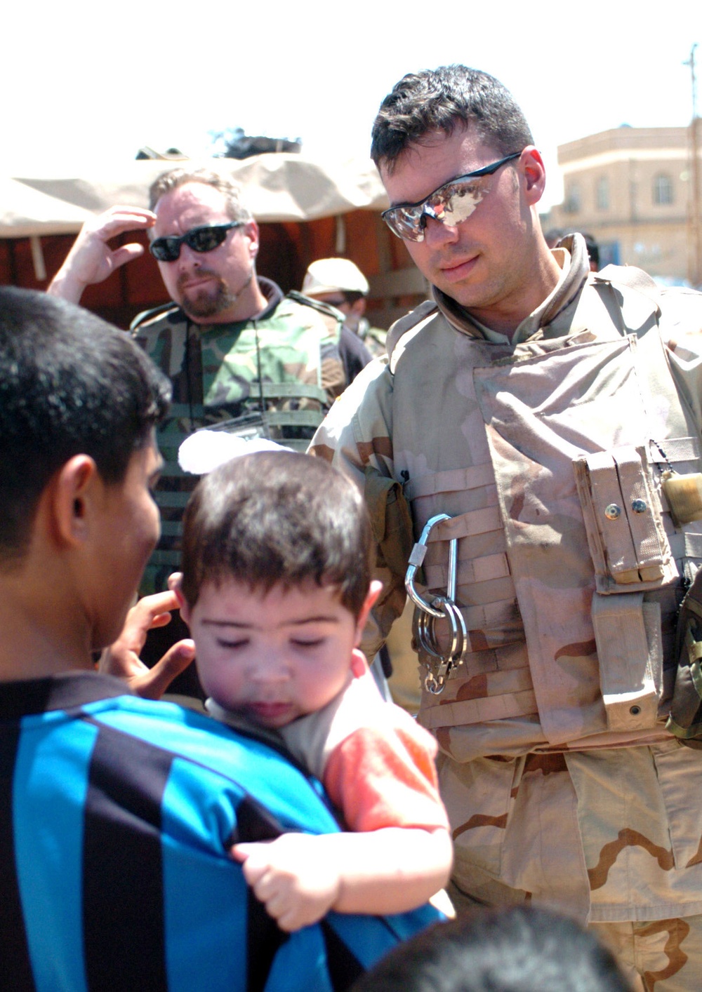 Spc. Kris A. Zientara hands out toys to children