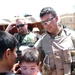 Spc. Kris A. Zientara hands out toys to children