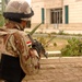 An Iraqi Soldier covers a window