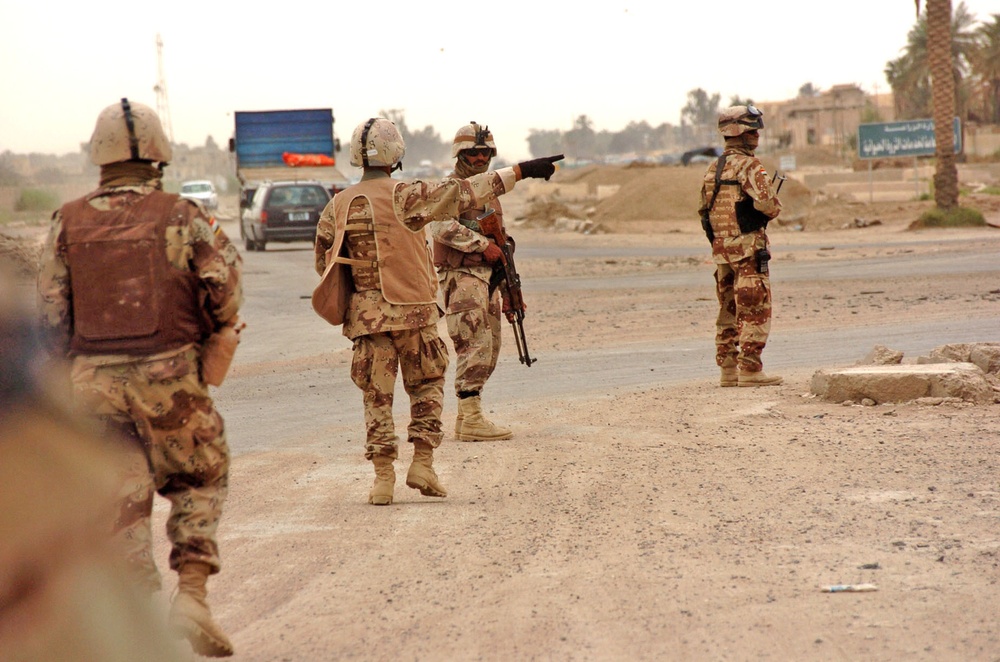 A squad patrols the streets of Abu Ghraib