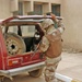 An Iraqi Soldier searches the back of vehicle