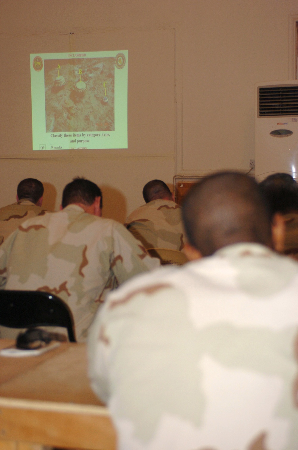 Soldiers take a visual test, identifying the unexploded ordnance