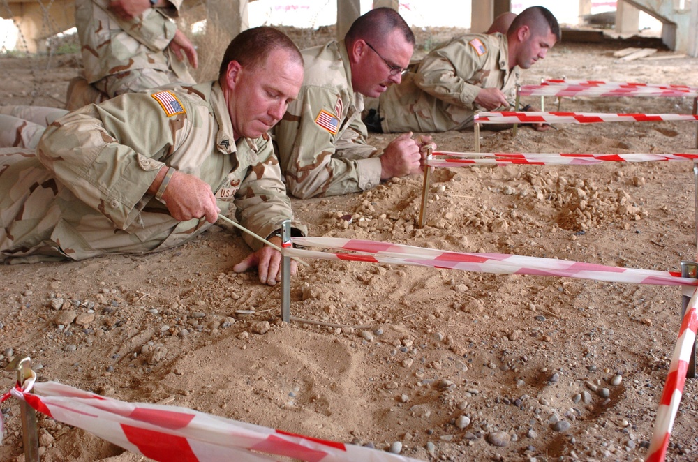 Soldiers probe for mines during a three-day EHAT class